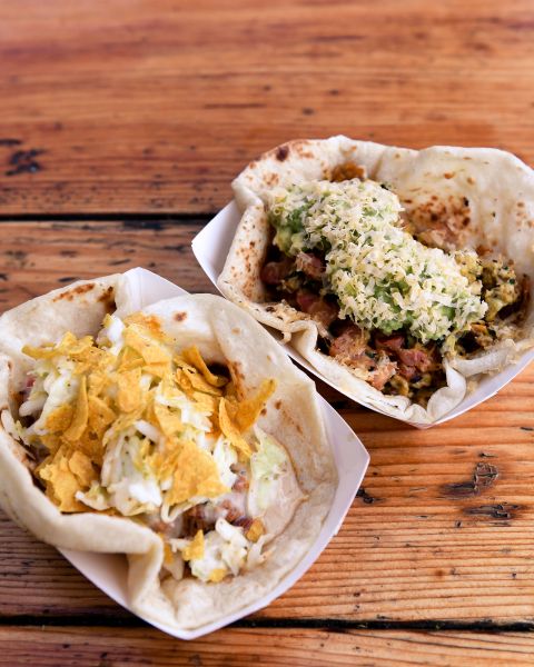 two tacos on a wooden table