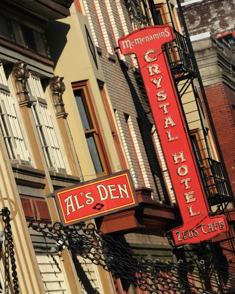 A historic building with a variety of business signs