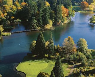 arial shot of golf course with lake