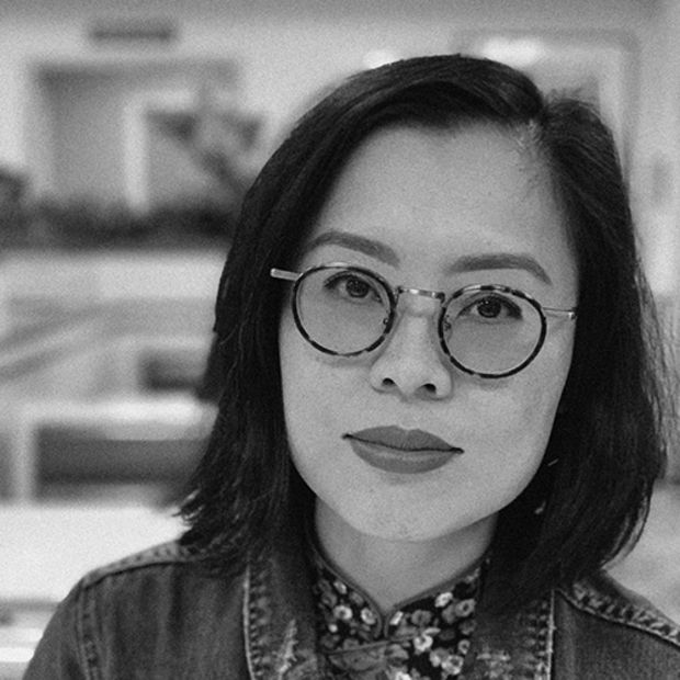 black and white headshot of woman wearing glasses