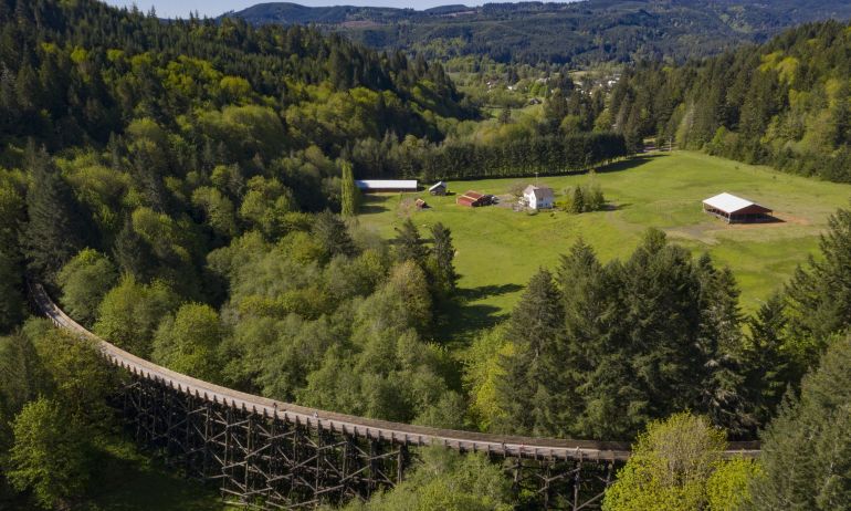 aerial view of the countryside and coastal range with an old rail bridge turned bike and walking path