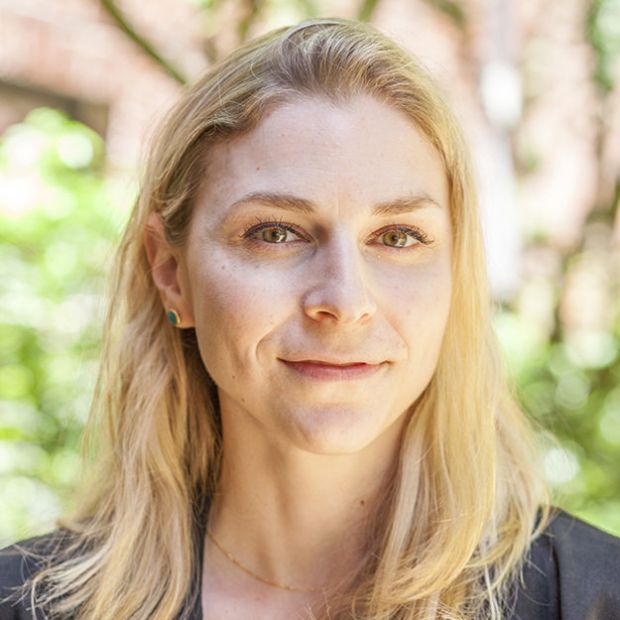 headshot of a woman in front of foliage