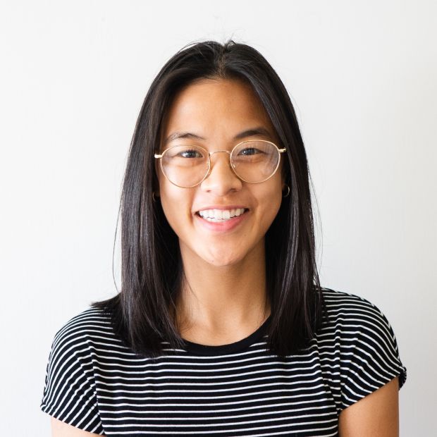 headshot of person smiling in striped shirt