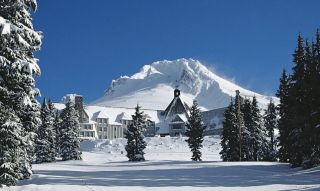 Timberline lodge covered in snow on a sunny day