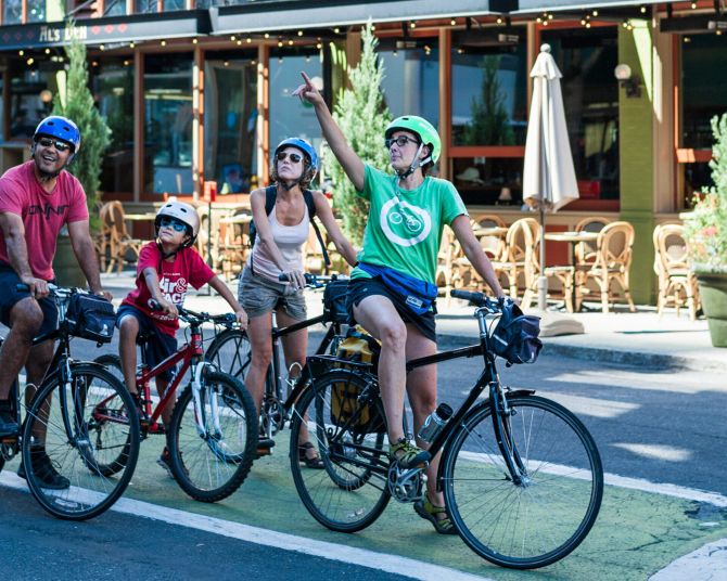A family enjoys a bike tour of downtown Portland.