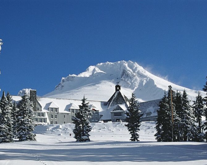 Timberline lodge covered in snow on a sunny day
