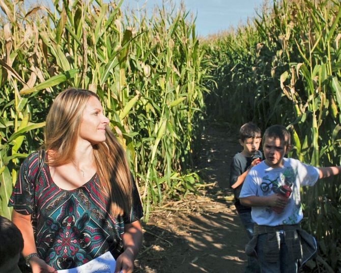 A woman and three children find their way through the tall corn at the Corn Maize at The Pumpkin Patch on Sauvie Island.