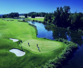aerial view of golf course with golfers on a sunny day