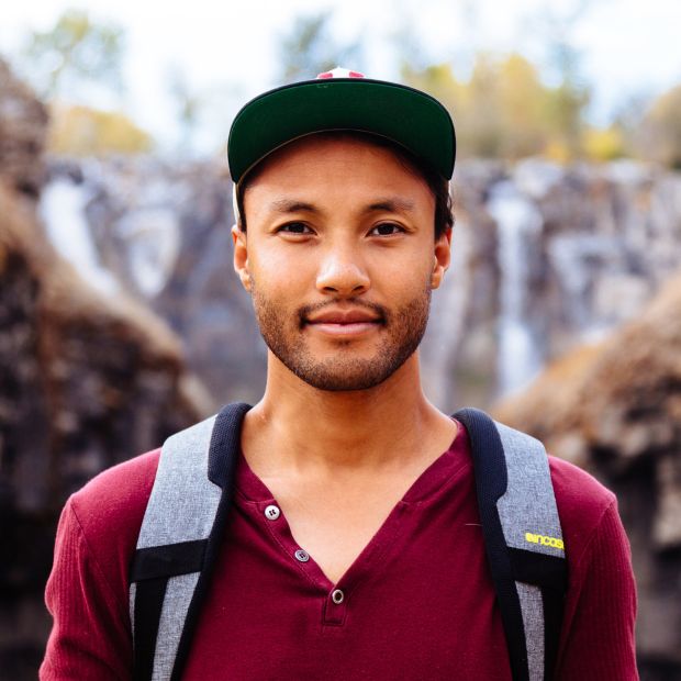 headshot of person wearing a hat