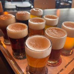 nine beers sit in a wooden tasting tray at a gluten free brewery