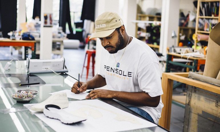 a designer looks at a sneaker