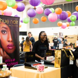 A vendor greets an attendee at My People\'s Market
