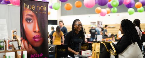 A vendor greets an attendee at My People\'s Market