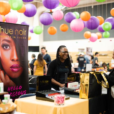 A vendor greets an attendee at My People\'s Market