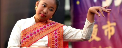 a dancer wearing a colorful sash