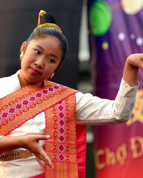 a dancer wearing a colorful sash