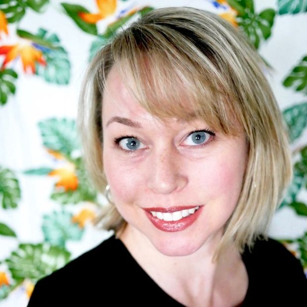 a headshot of a woman with short blond hair