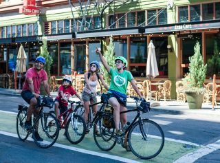 A family enjoys a bike tour of downtown Portland.