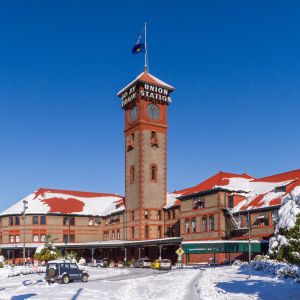 train station surrounded by snow-covered streets and shrubs