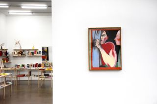 Art gallery with painting of two people in forefront and room with shelves in background