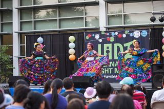 dancers on stage showcase traditional vibrant dresses while performing