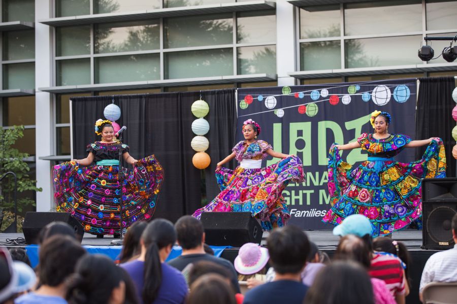 dancers on stage showcase traditional vibrant dresses while performing