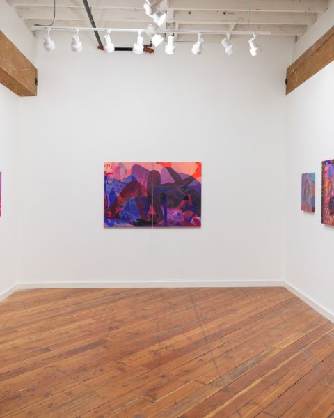 white walled interior of an art gallery with 6 paintings hanging on three sides of an open room