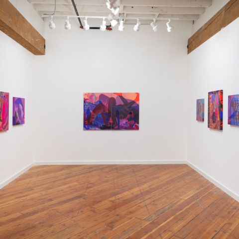 white walled interior of an art gallery with 6 paintings hanging on three sides of an open room