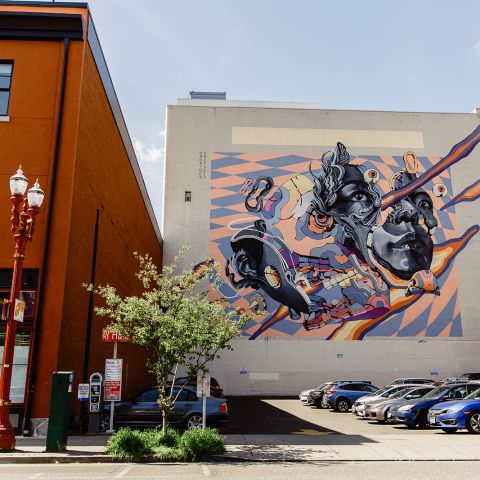 mural on side of building on a city street