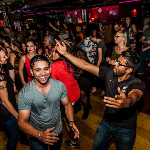 a crowd of people dancing at a night club