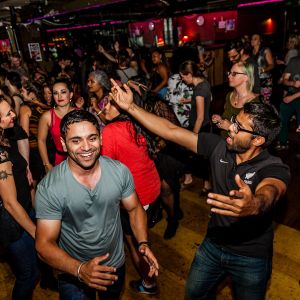 a crowd of people dancing at a night club