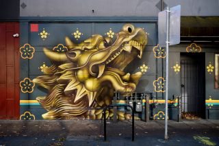 Aerosol and latex painted mural of a golden horse and flowers