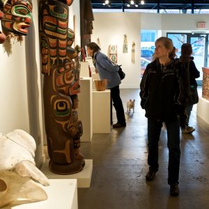 people admiring Native American art on display in a gallery