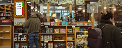 people at books shelves in a books store