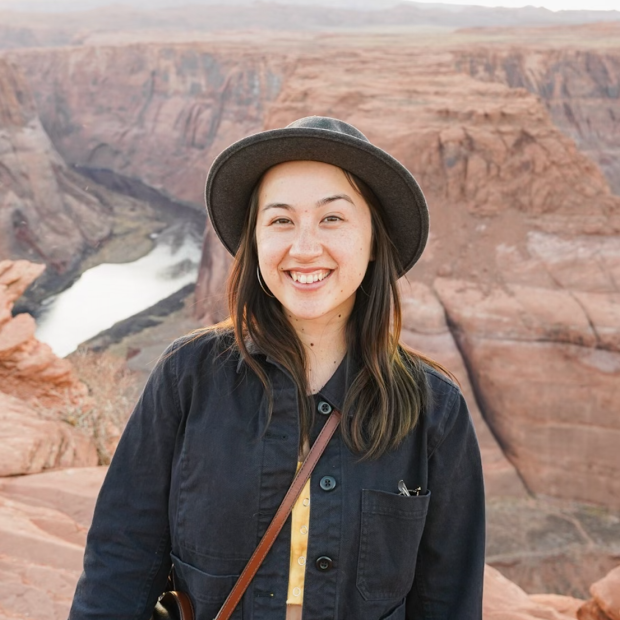 close up of a person standing in front of the Grand Canyon